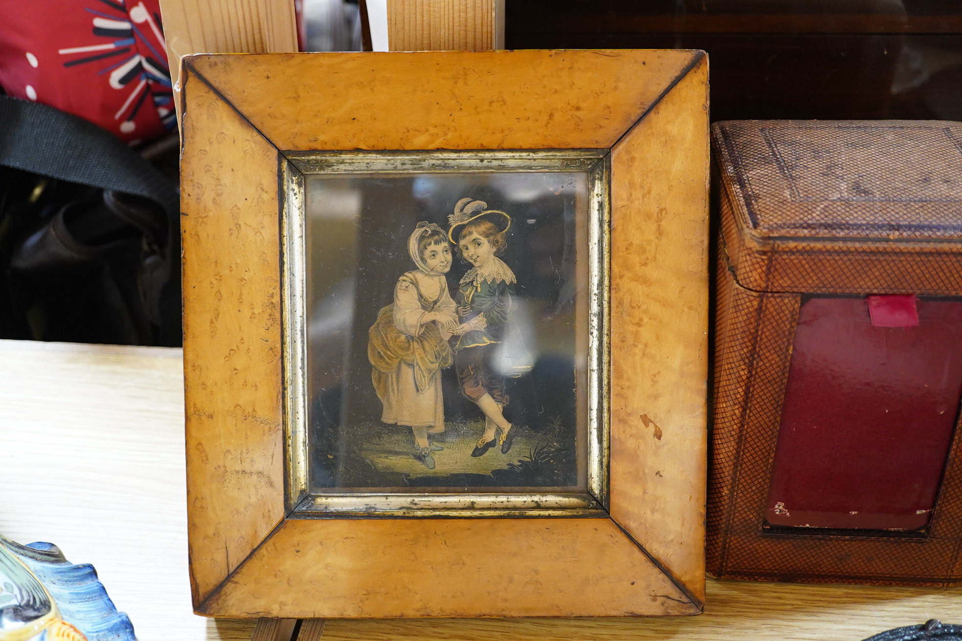 Two framed pot lids, two oval figural plaques,a moustache cup and saucer, two Bretby cats, framed print and mixed nut crackers cutlery etc